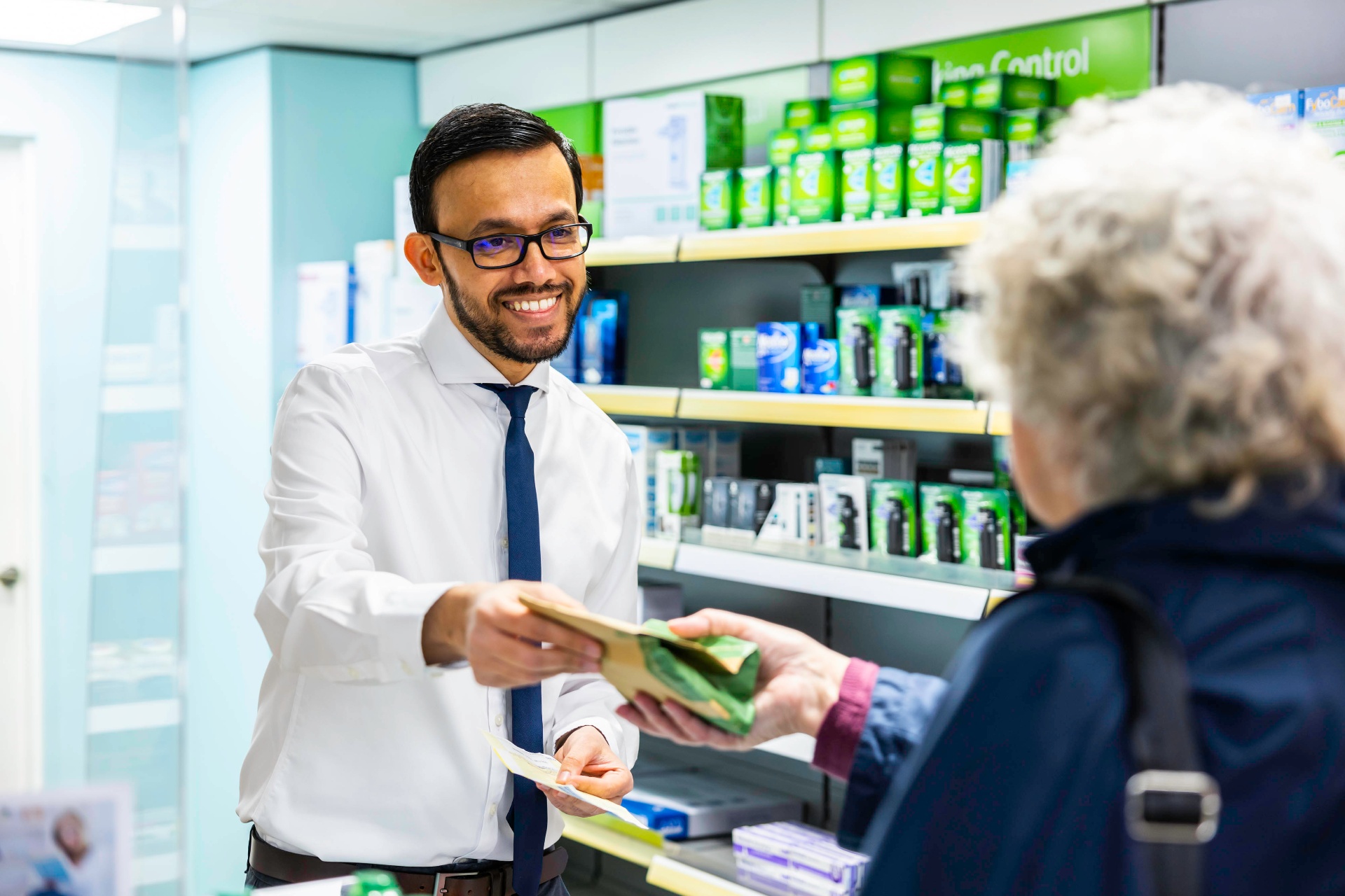 Pharmacist serving a patient at Ringmer Pharmacy