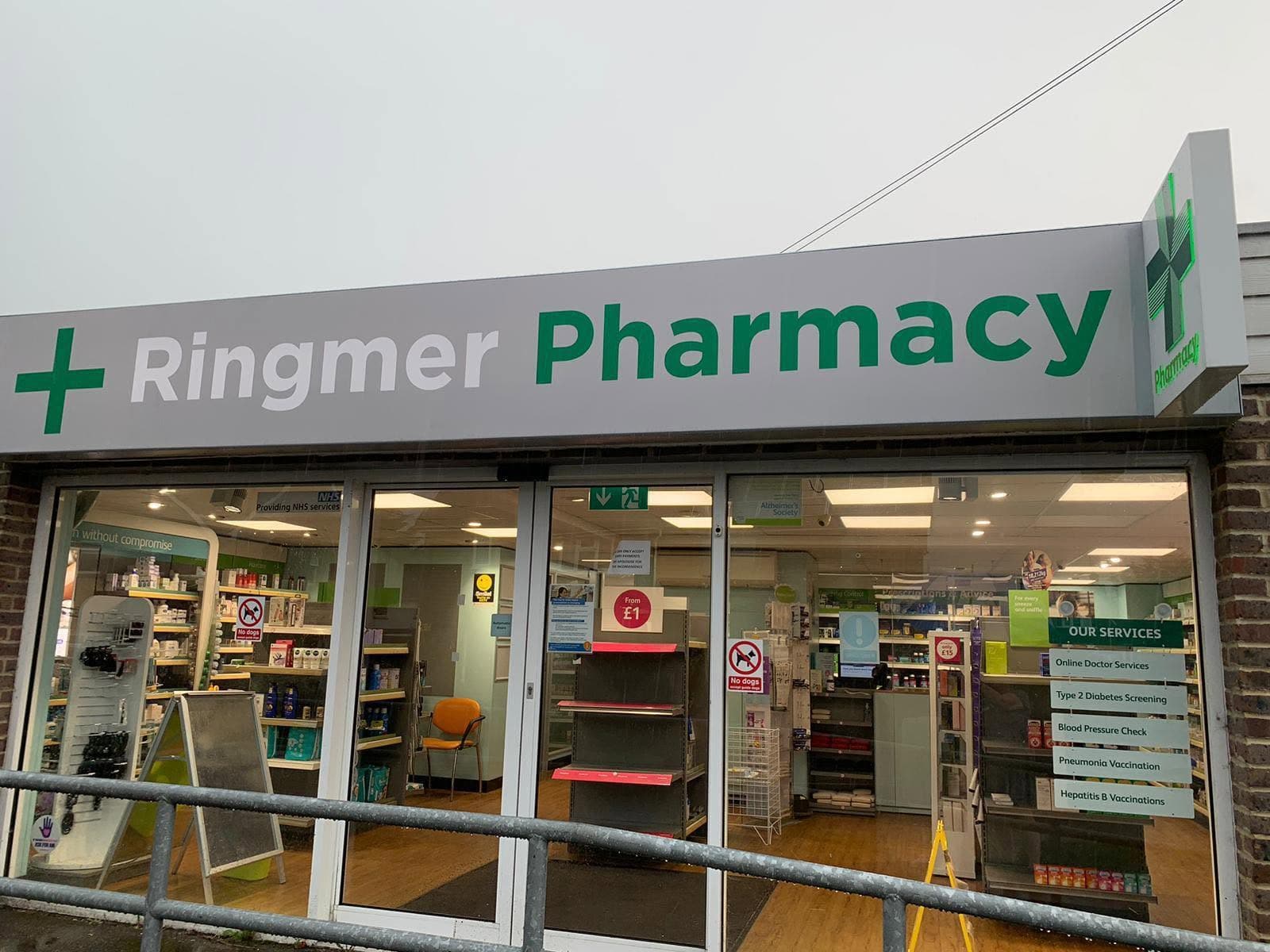 Ringmer Pharmacy storefront and green cross sign in Ringmer